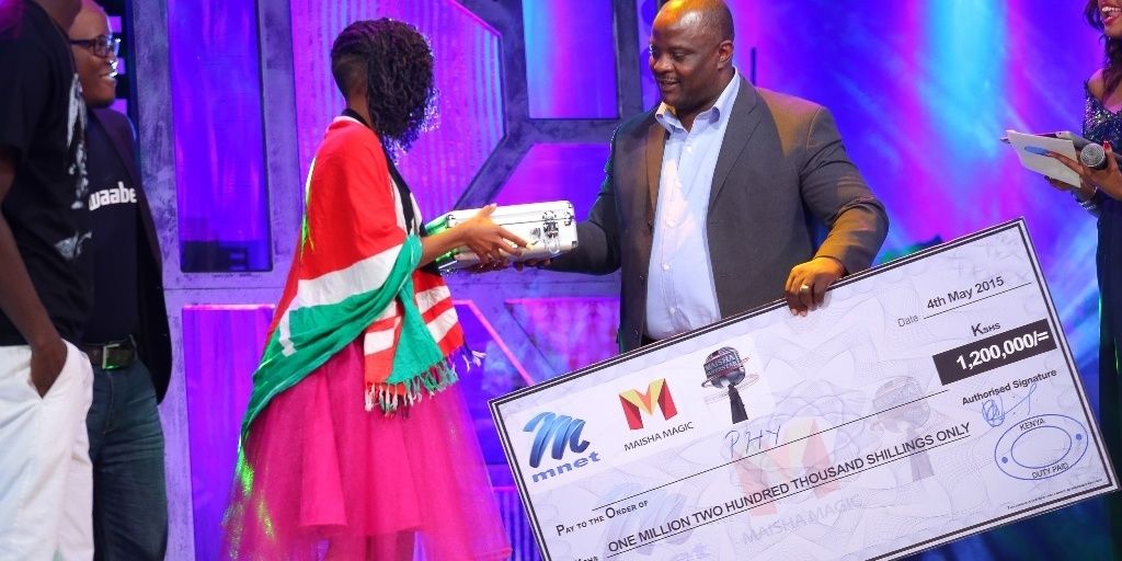 34 mr chiruyi of mck hands of a microphone and winners cheque to phy